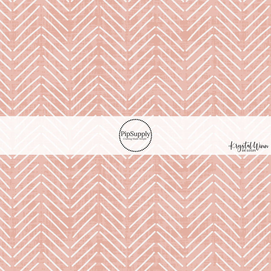 These blush fabric by the yard features white arrows on blush.