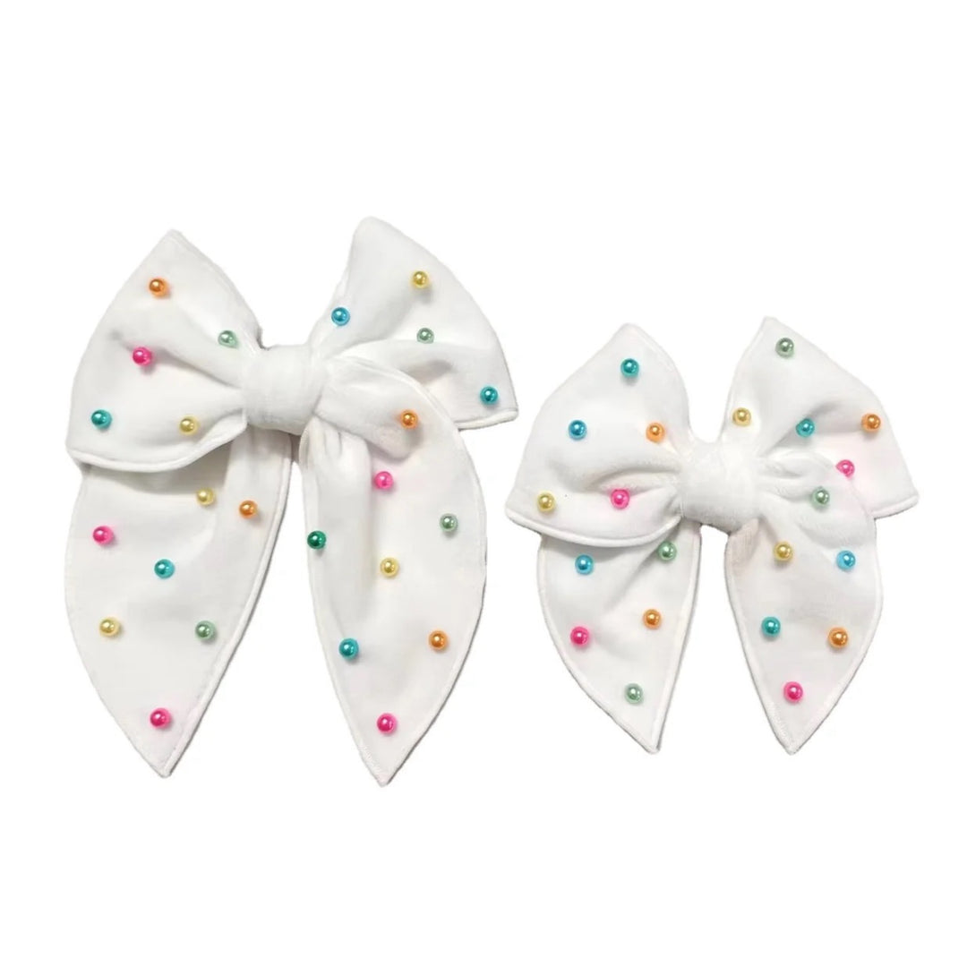 These spring white velvet pearl tied bows are ready to package and resell to your customers no sewing or measuring necessary! These hair bows come with a alligator clip already attached. Along with pastel multi colored pearls.