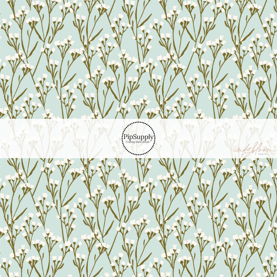 This summer fabric by the yard features cream wildflowers on light blue. This fun summer themed fabric can be used for all your sewing and crafting needs!