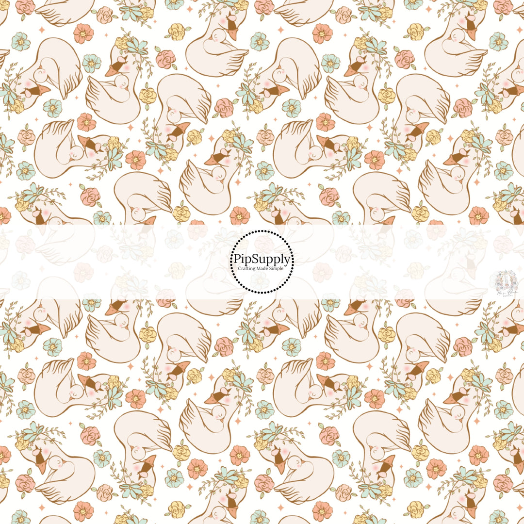 This spring floral fabric by the yard features swans and pastel flowers. This seasonal pattern fabric can be used for all your sewing and crafting needs!