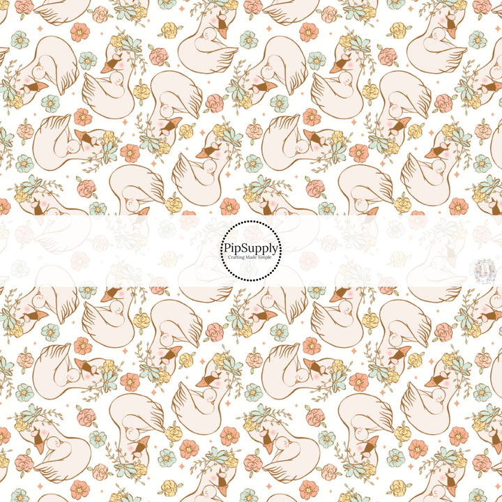 This spring floral fabric by the yard features swans and pastel flowers. This seasonal pattern fabric can be used for all your sewing and crafting needs!