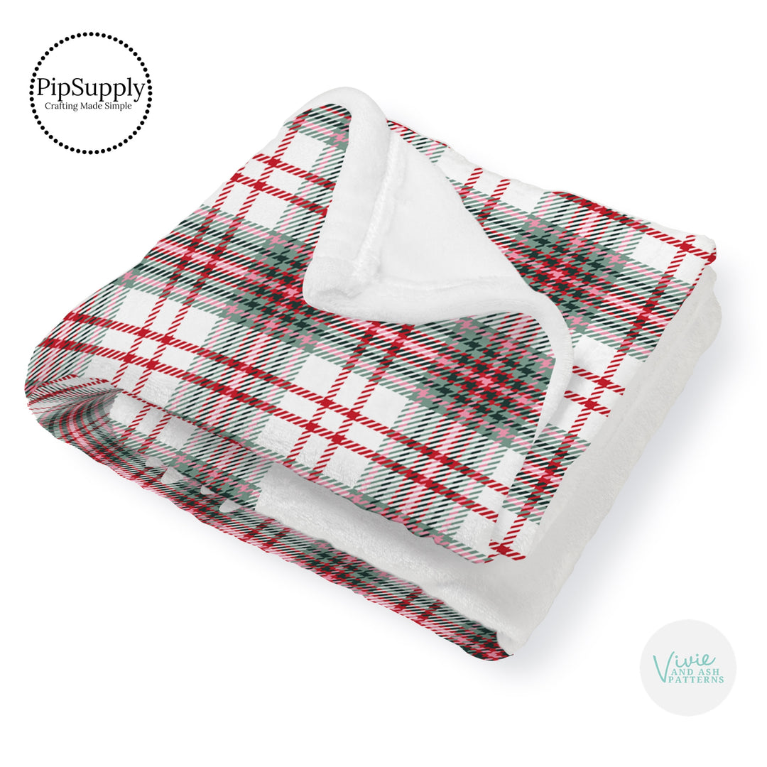 This winter designer pattern is printed onto the front side of our soft touch minky blankets. The backside will not be printed and left the natural cream/white color of the blanket. This print pattern features Christmas red and green plaid pattern.