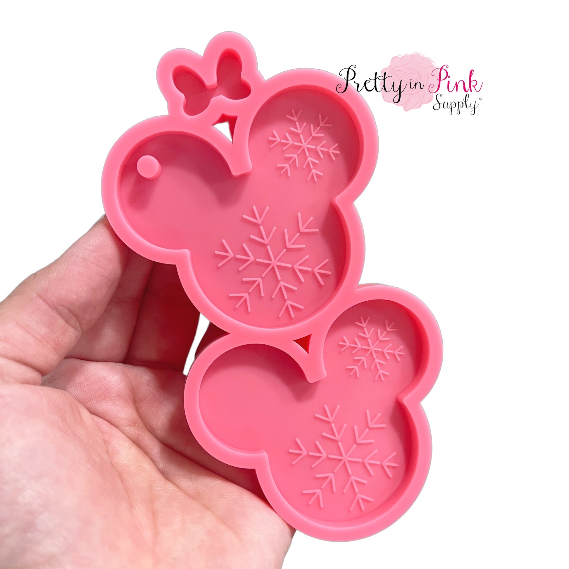 AB resin pink silicone mold of mouse ears with snowflakes and bow.