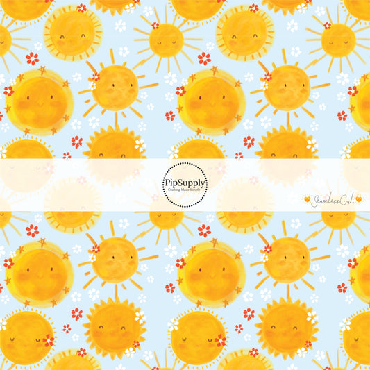 Animated yellow suns on light blue fabric by the yard with white and red floral prints.