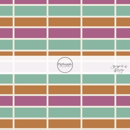 Plum, seafoam, and orange tiles seperated by cream lines on bow strips