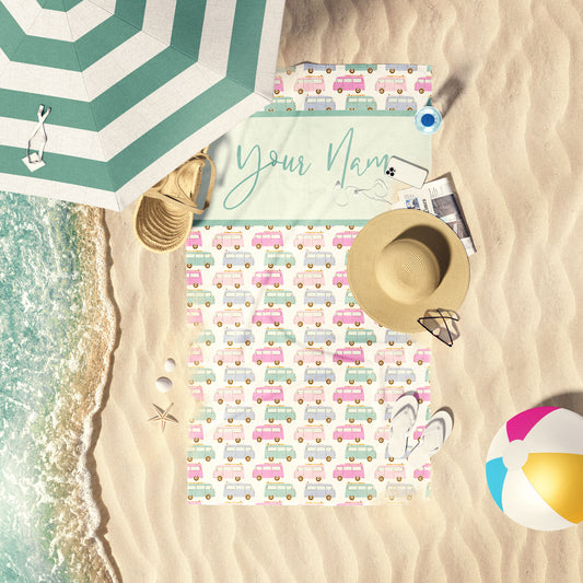 Surfs Up Pastel print customizable beach towel laid out on the beach sand.