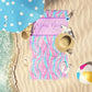Mermaid marble swirl print customizable beach towel laid out on the sand.