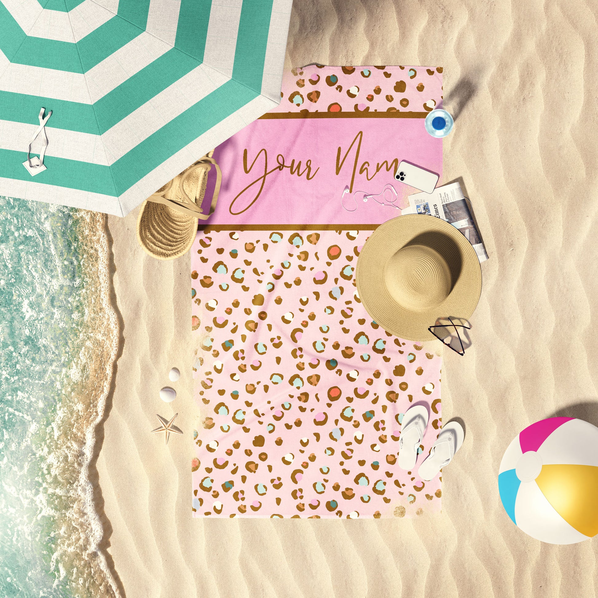 Multi bubblegum Cheetah print customizable beach towel laid out by the shore.