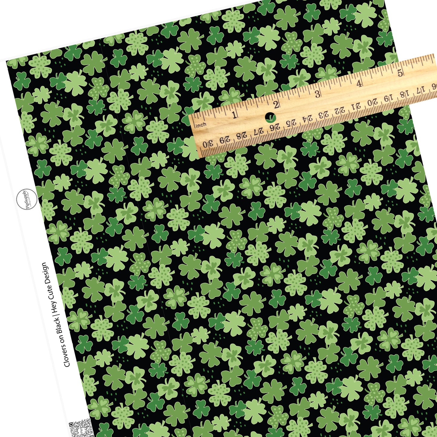 4 leaf clovers with light green hearts and light green clovers with dark green polka dots and disperse dots on a black faux leather sheet