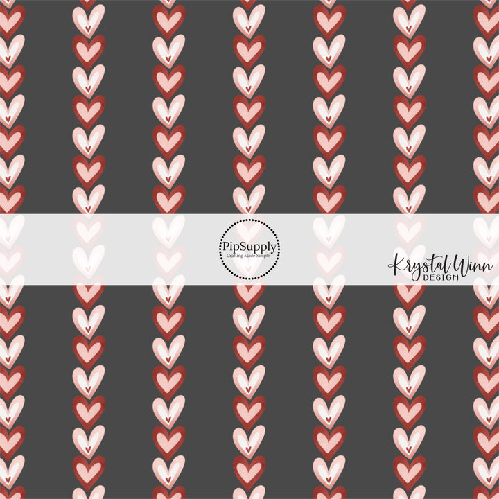 Black fabric by the yard with red and pink vertical hearts