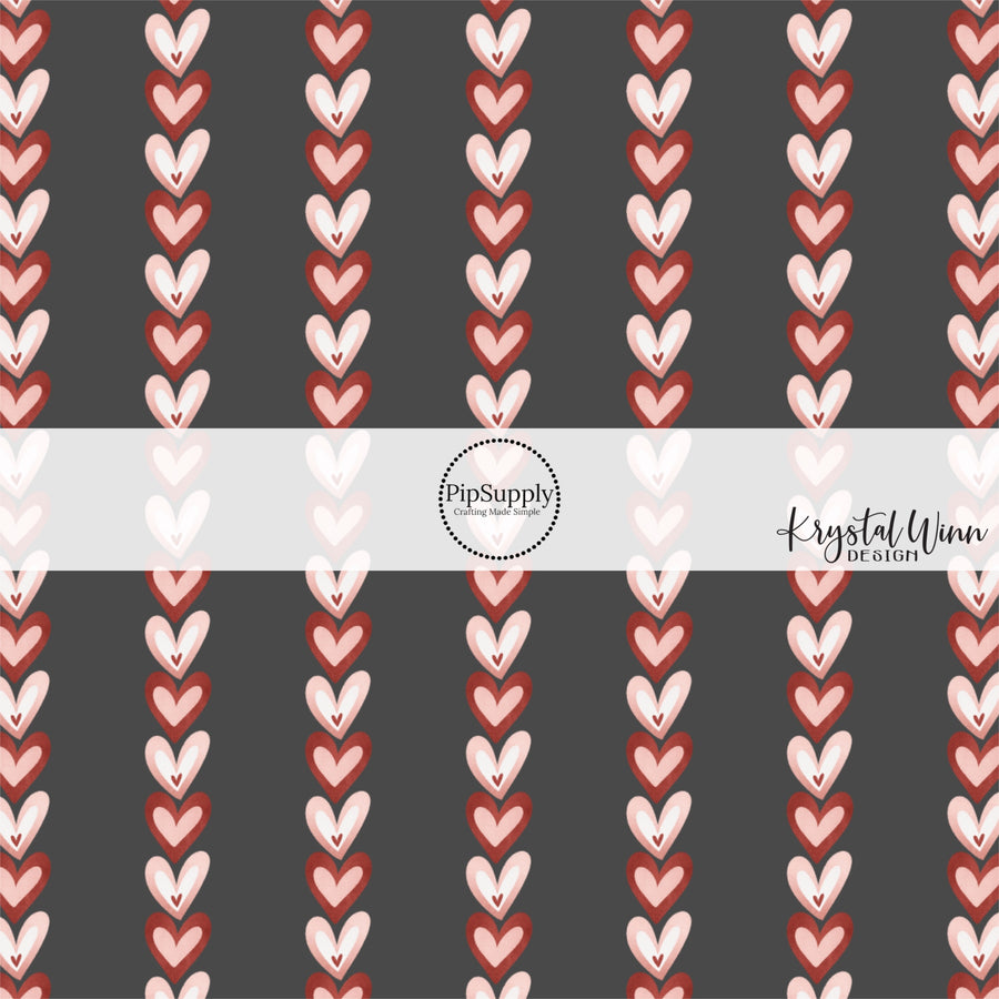 Black fabric by the yard with red and pink vertical hearts