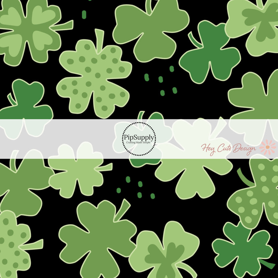 Black fabric by the yard with green polka dot shamrocks 