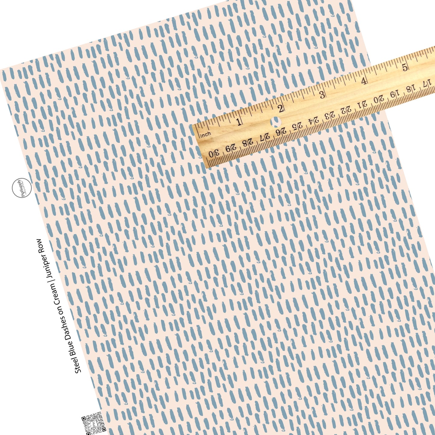 Scattered blue marks on cream faux leather sheet