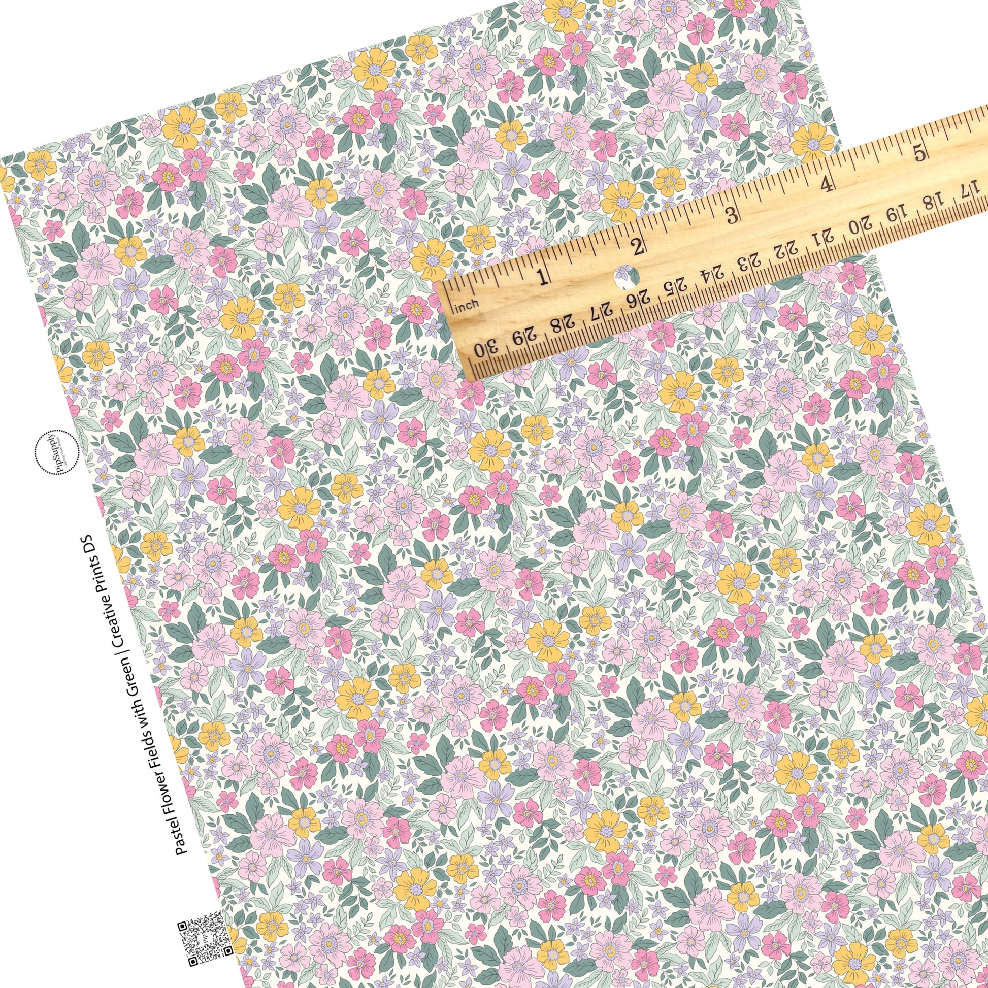 Green leaves on yellow, pink, and lilac flowers on white faux leather sheet