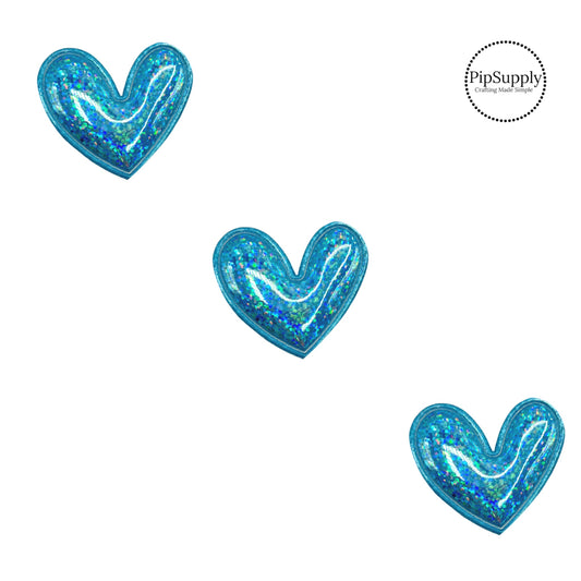 bright holographic blue two inch heart embellishment with fabric backing for bows and crafting