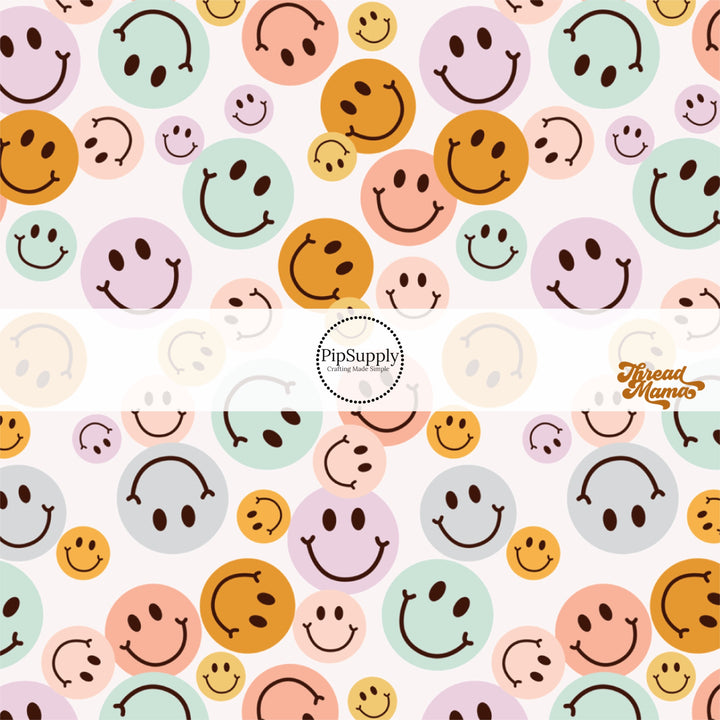 Scattered blue, lavender, pink, and orange smiley faces bow strip