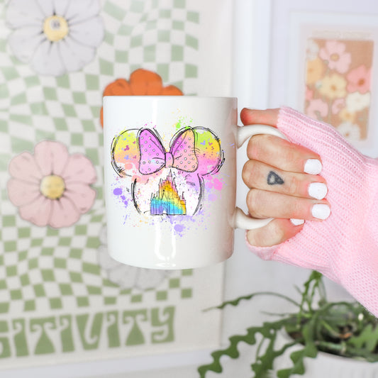 Vibrant rainbow mouse ears and magical castle adhesive sticker on a white mug