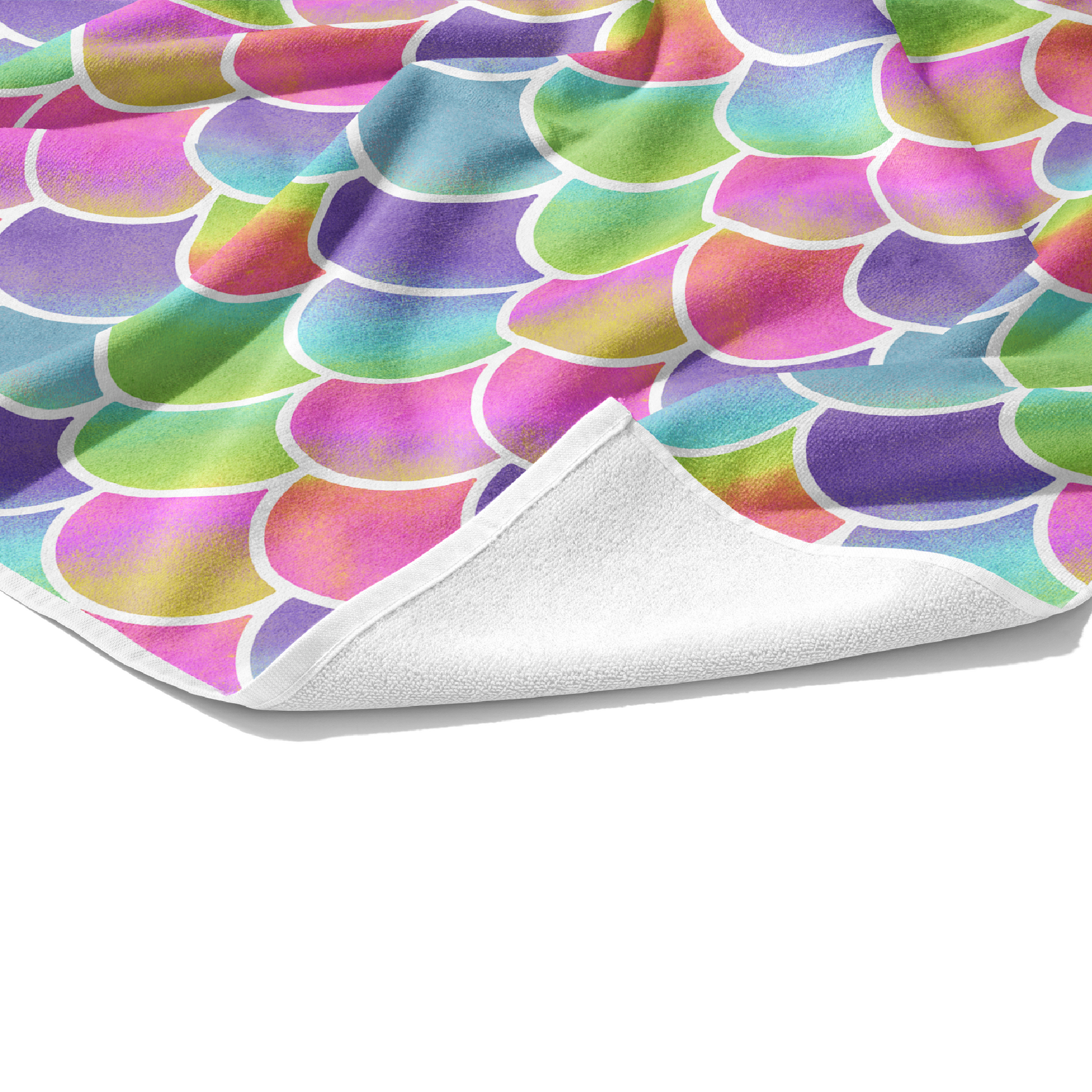 Plush white cotton towel with bright rainbow ombre mermaid scales outlined in white printed on the towel front.