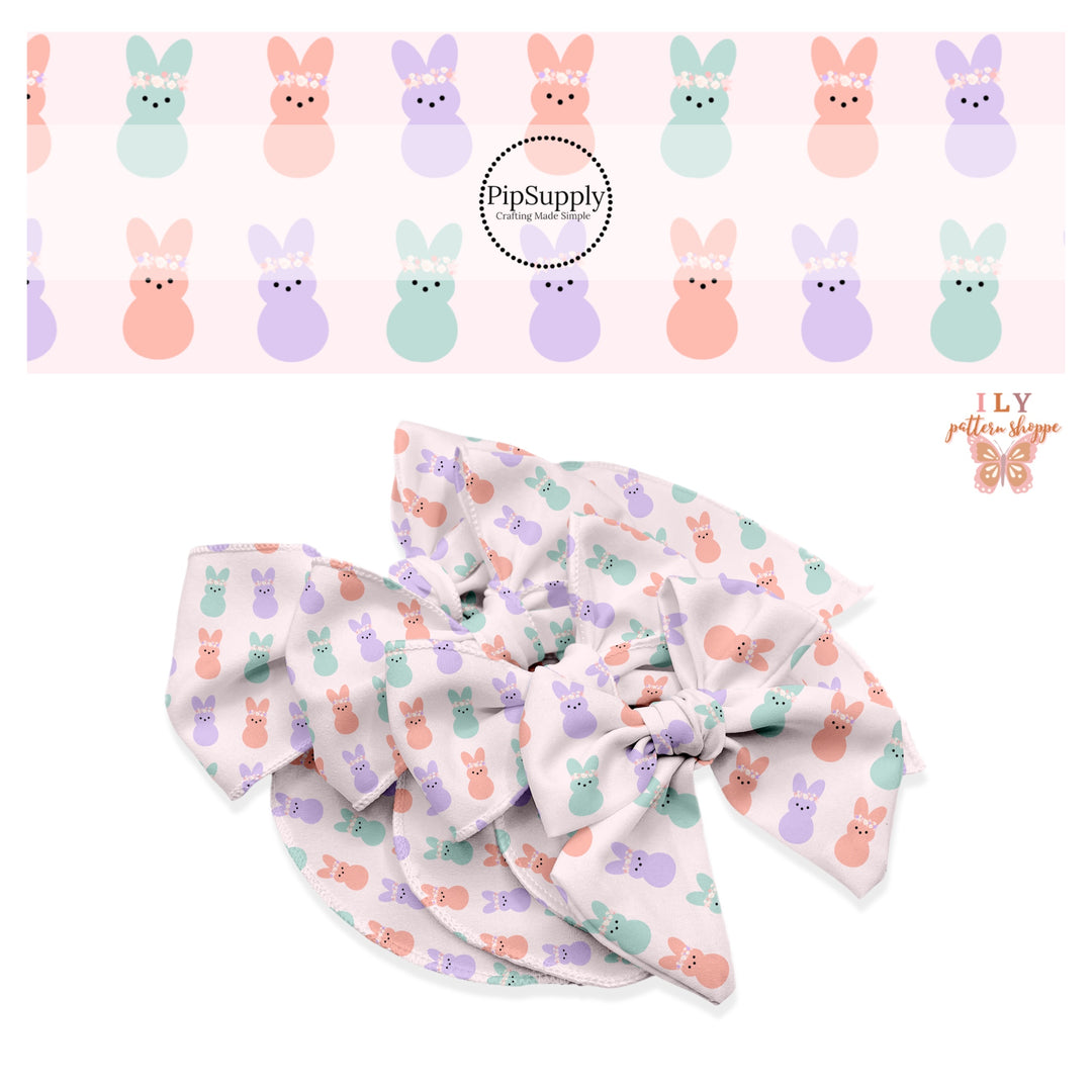 Pink, purple, and aqua marshmallow bunnies with floral crowns on light pink bow strips