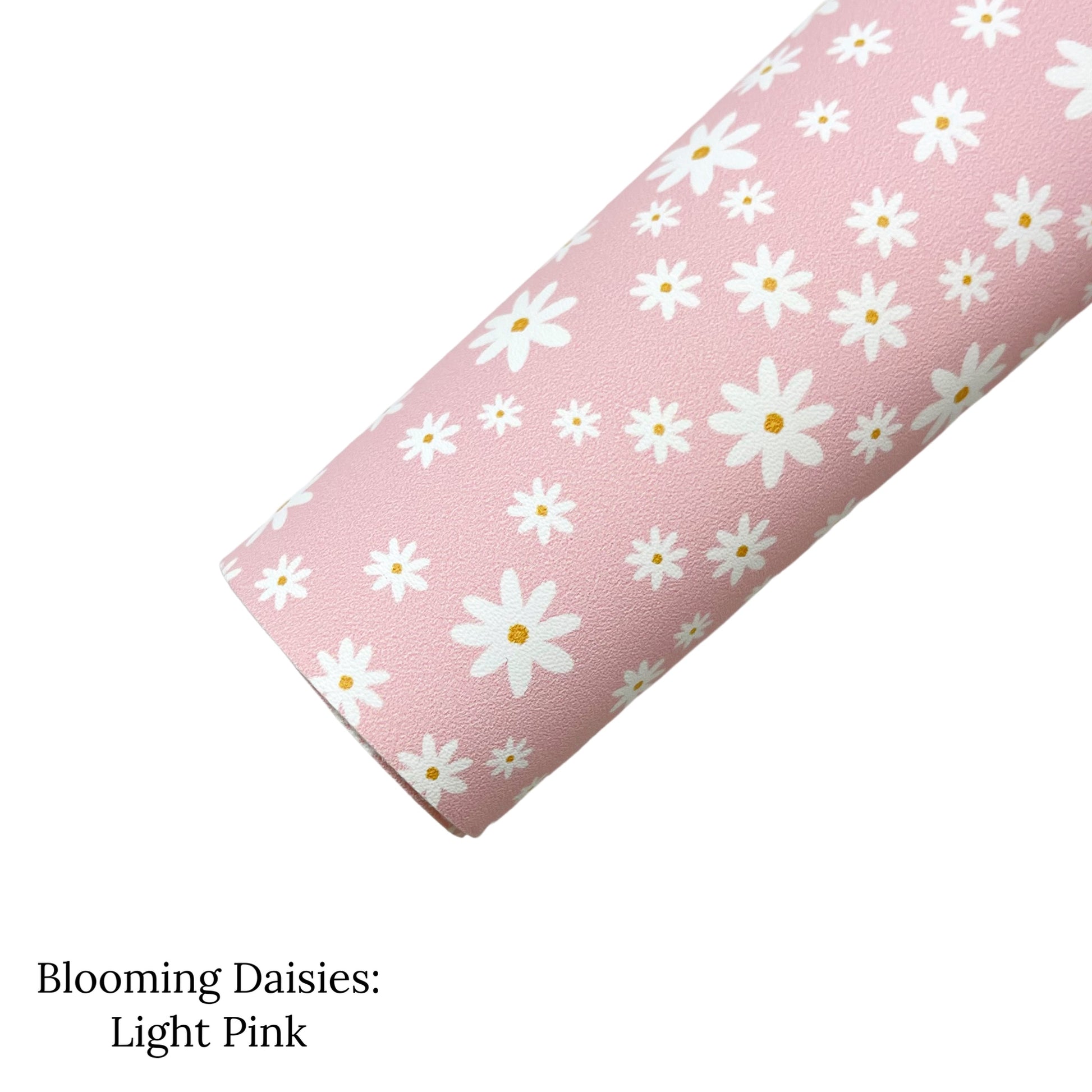 Rolled pale pink faux leather sheet with white and yellow daisy pattern.