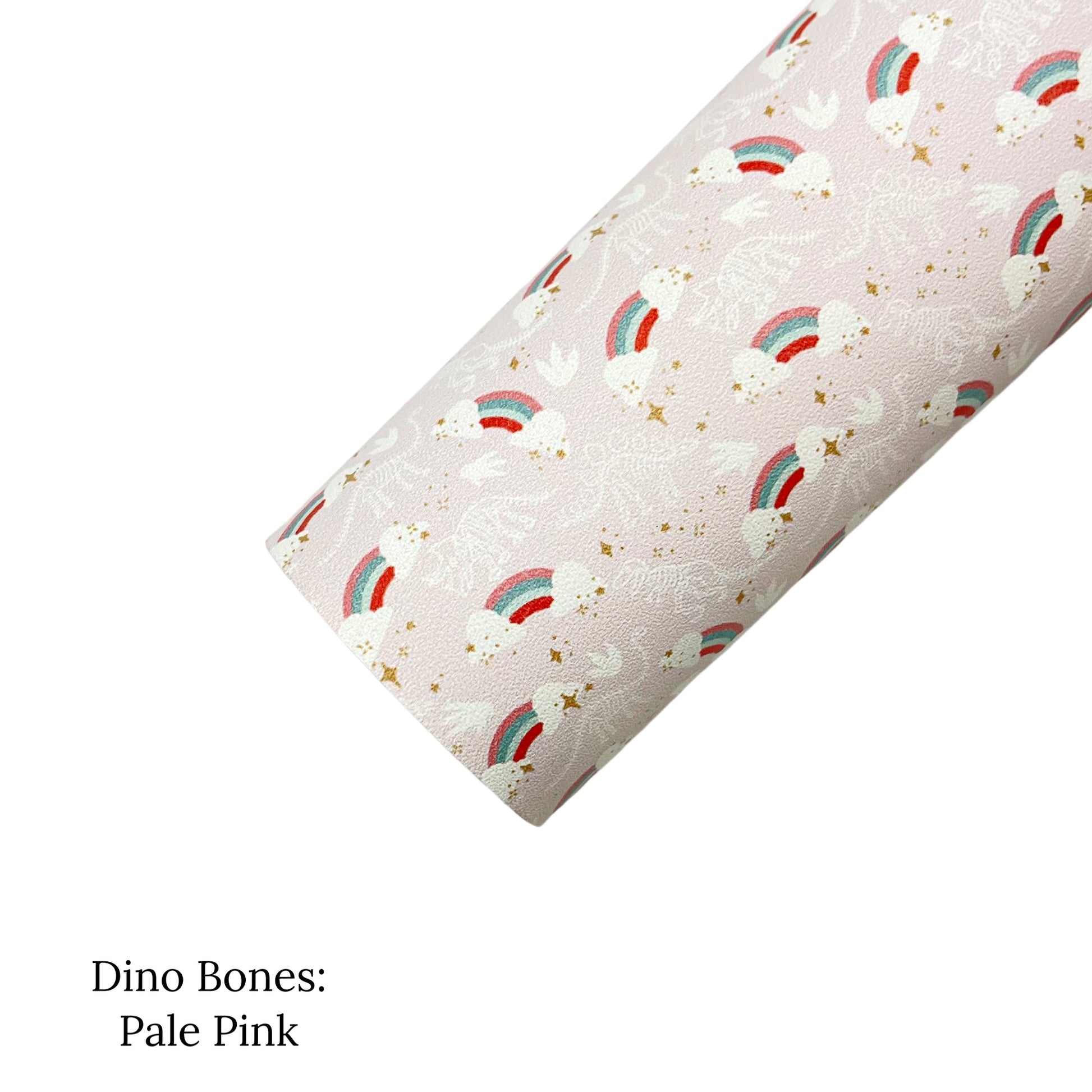 Rolled pale pink faux leather sheet with white dinosaur bones, claw prints, gold stars, and retro rainbow pattern.