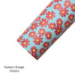 Rolled sky blue faux leather sheet with rust red orange carnation daisy flower pattern.