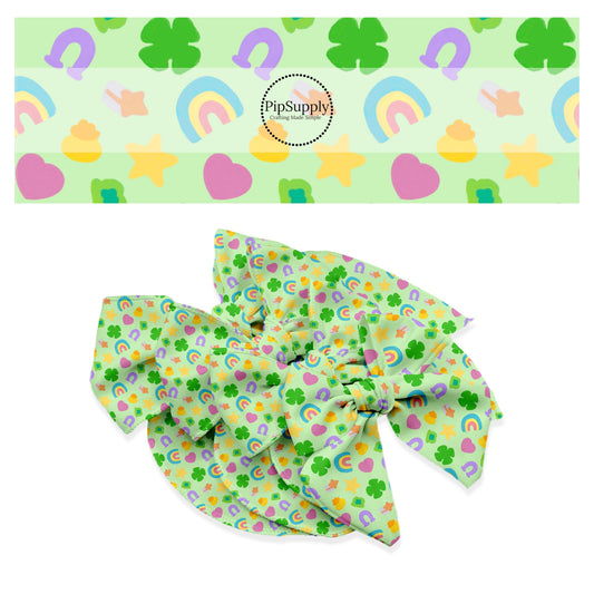 Green clover, rainbows, pink hearts, horseshoe, and gold stars charms on light green bow strip