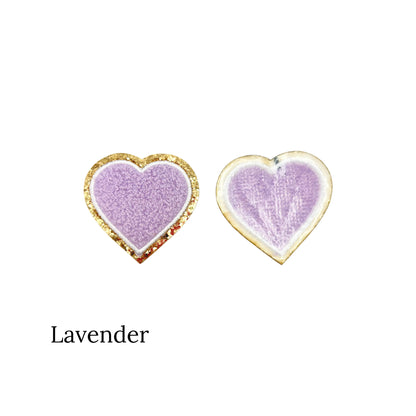 Purple iron on patch on a white and gold glitter border in a heart shape