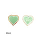 mint green iron on patch on a white and gold glitter border in a heart shape