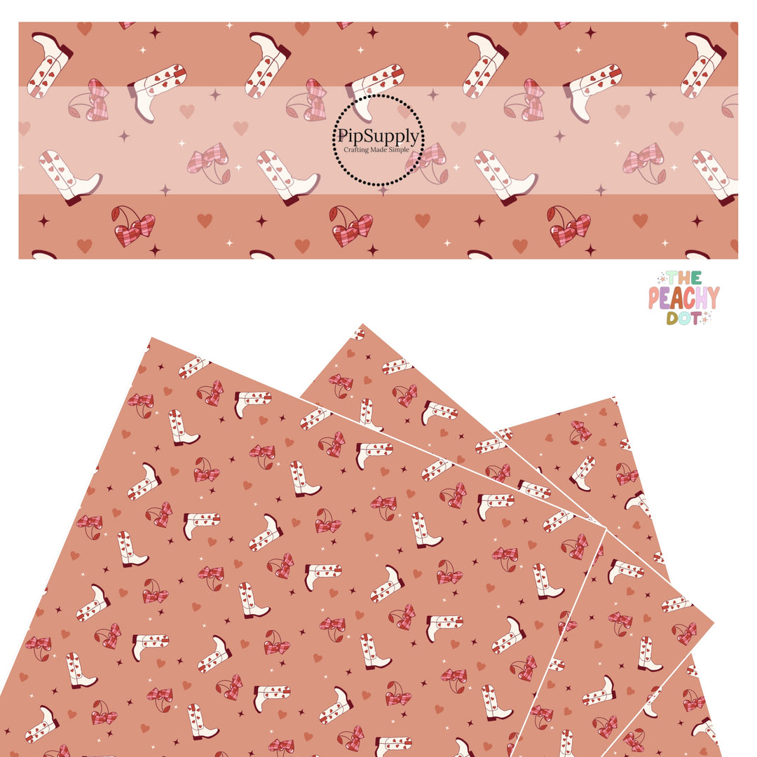 White boots with red hearts and pink and red cherries with red sparkles on a terracotta faux leather sheet