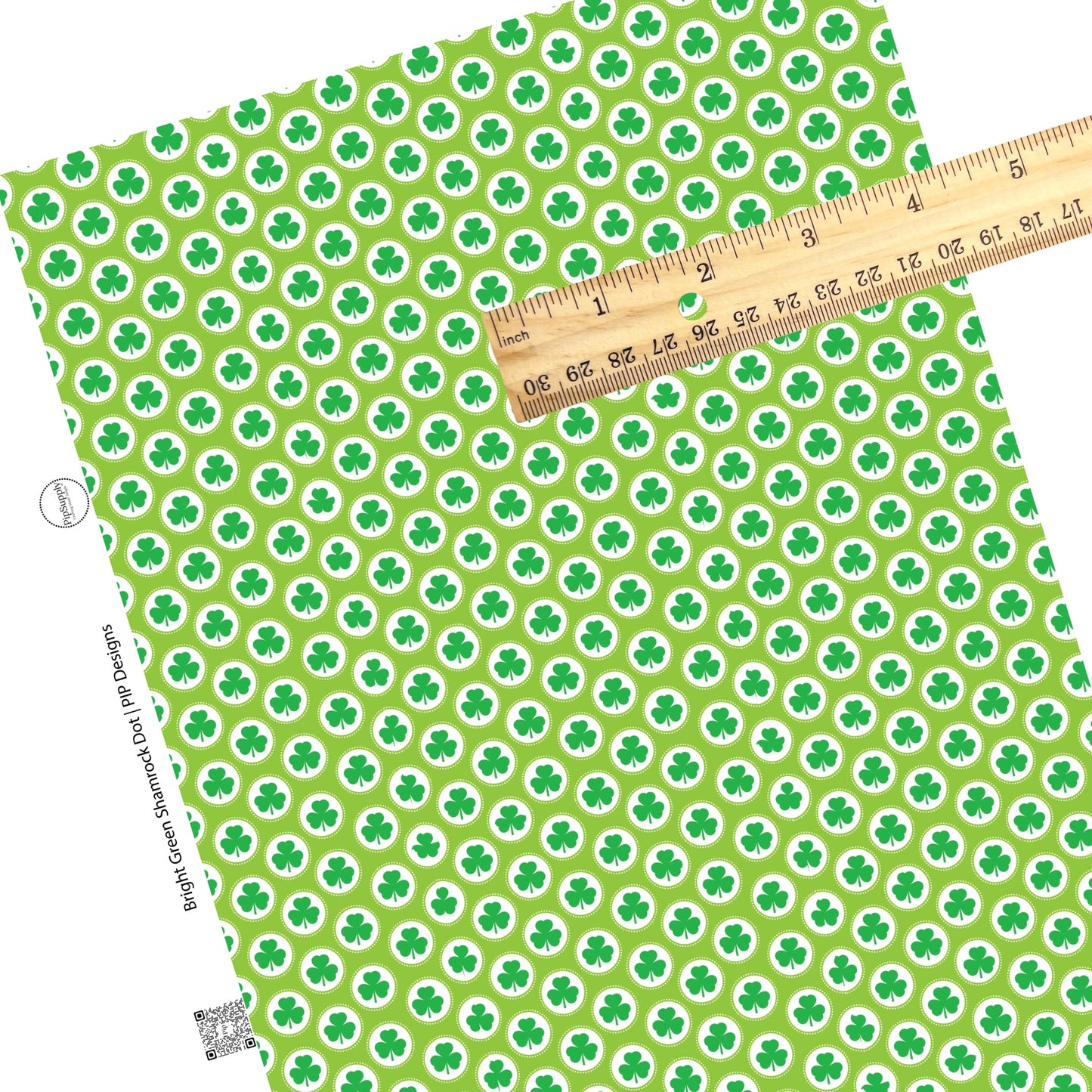 White circles with green clovers and polka dots on a green faux leather sheet