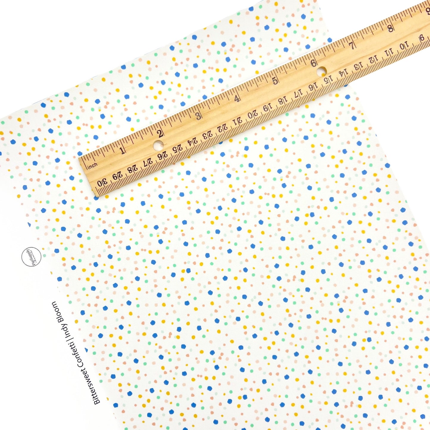 Mini Confetti dots on a cream faux leather sheet.