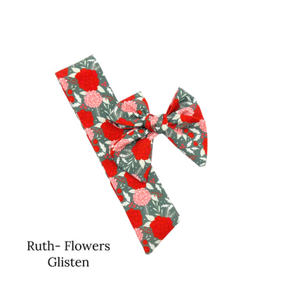Green christmas bow with red flowers