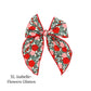 Green christmas bow with red flowers and leaves and red trim