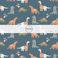 Dark blue fabric by the yard with white, orange, and blue dinosaurs as well as heart balloons.