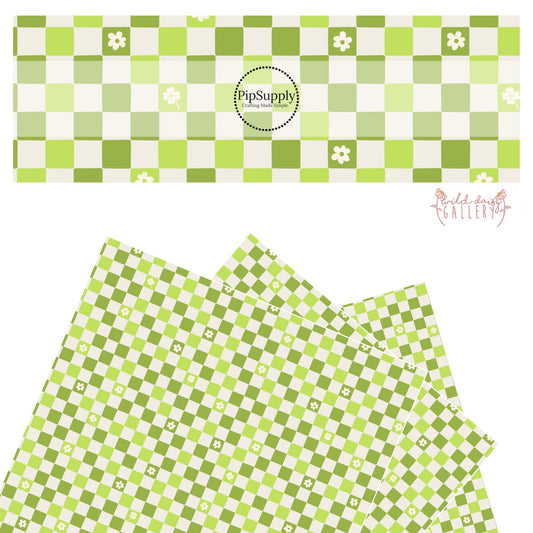 Different shades of green checker with cutout flowers and clovers on a light grey faux leather sheet