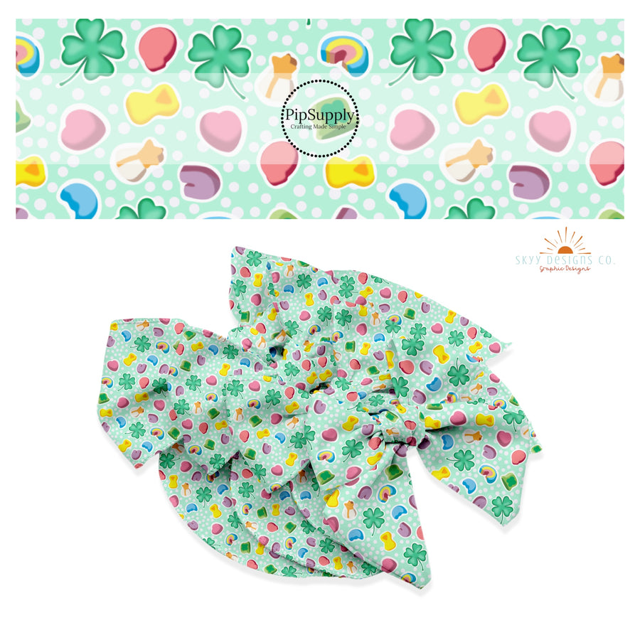 White polka dots with clovers, rainbows, and heart marshmallow charms on a light green bow strip