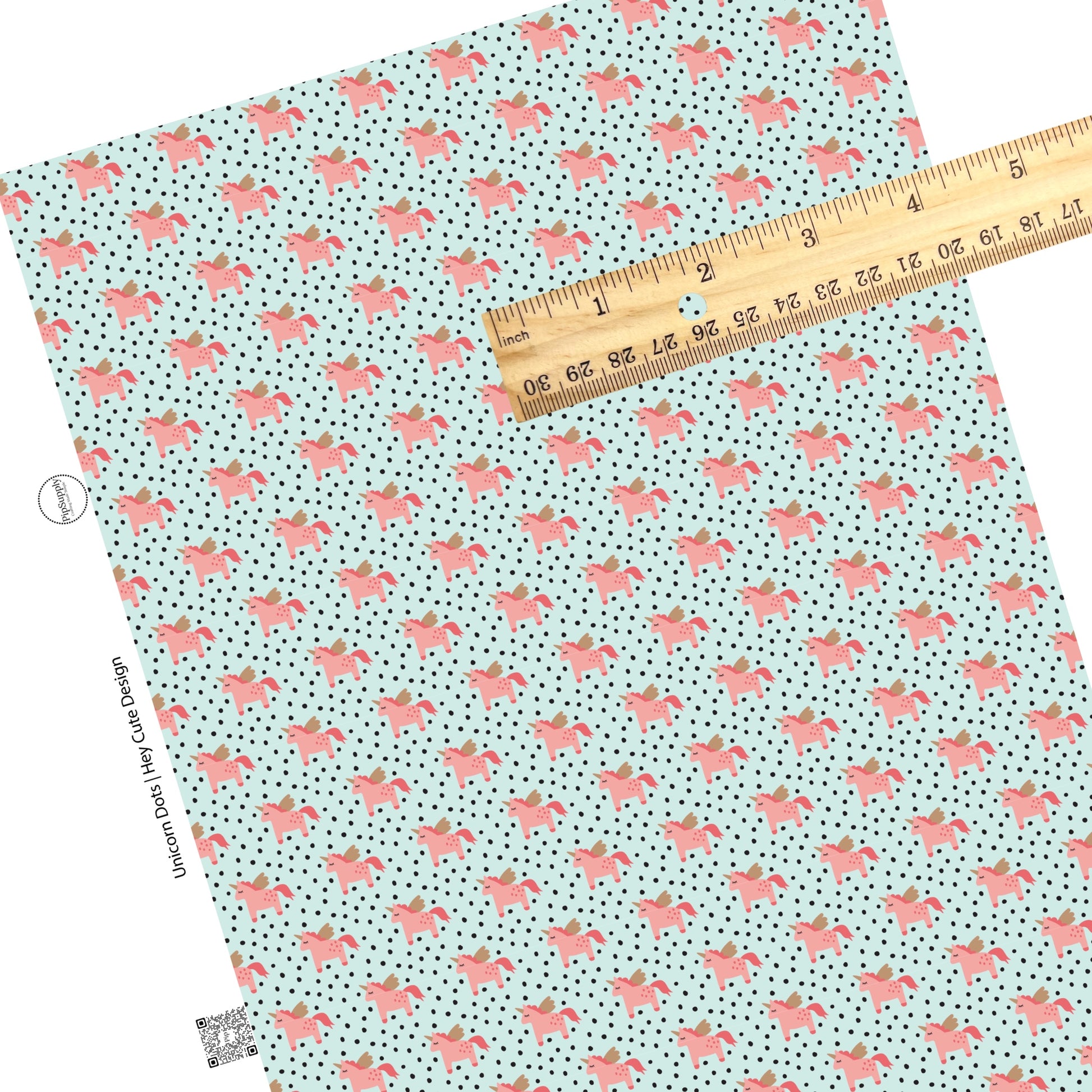 Pink unicorns with  gold horns and wings with black polka dots on aqua faux leather sheets