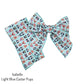 Tied and untied light aqua blue Isabelle style bow strip with Easter dogs pattern designed by Hey Cute Design.