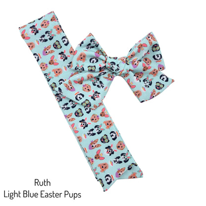 Tied and untied light aqua blue Ruth style bow strip with Easter dogs pattern designed by Hey Cute Design.