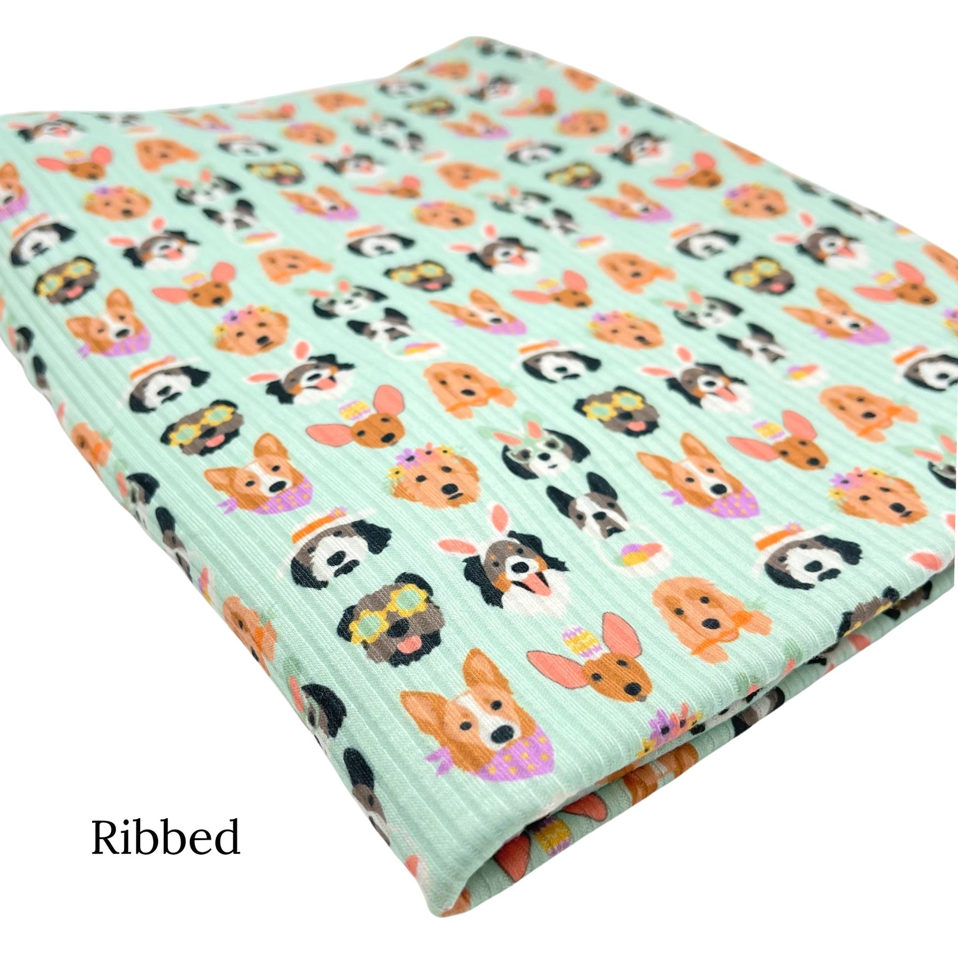 Folded light greenish blue ribbed fabric with Easter dogs pattern designed by Hey Cute Design.