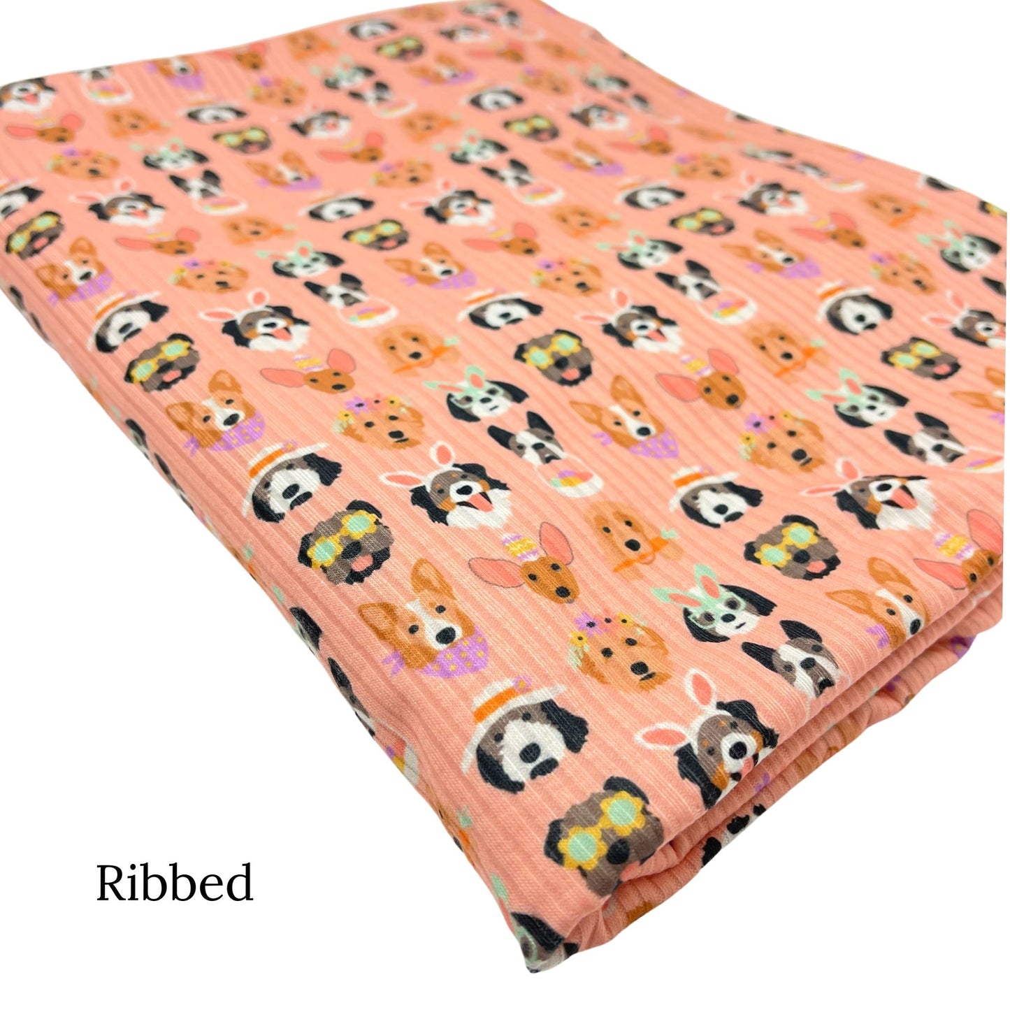 Folded light peachy pink ribbed fabric with Easter dogs pattern designed by Hey Cute Design.