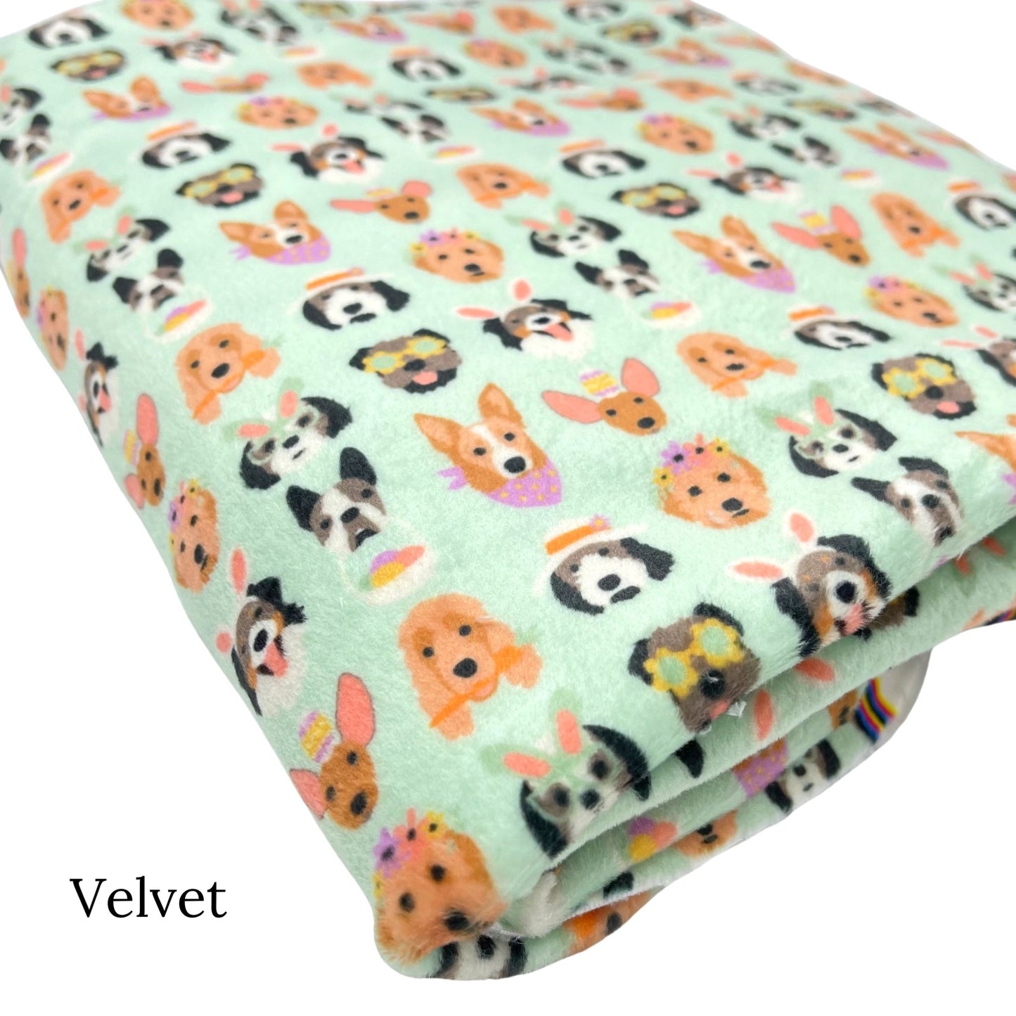 Folded light greenish blue Velvet fabric with Easter dogs pattern designed by Hey Cute Design.