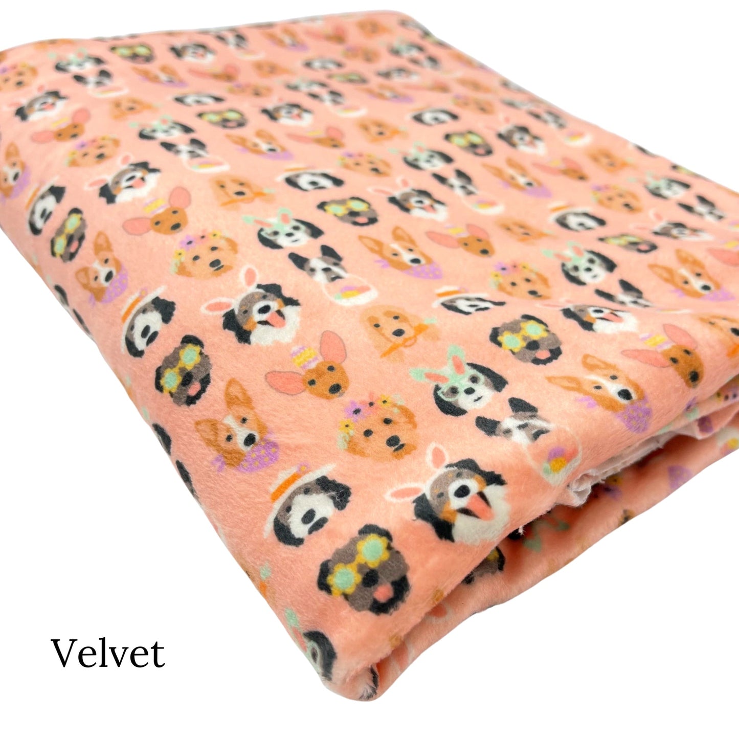 Folded light peachy pink Velvet fabric with Easter dogs pattern designed by Hey Cute Design.