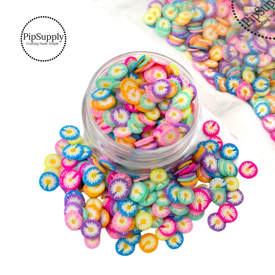 bright pink purple blue yellow round clay slices with white daisies on them