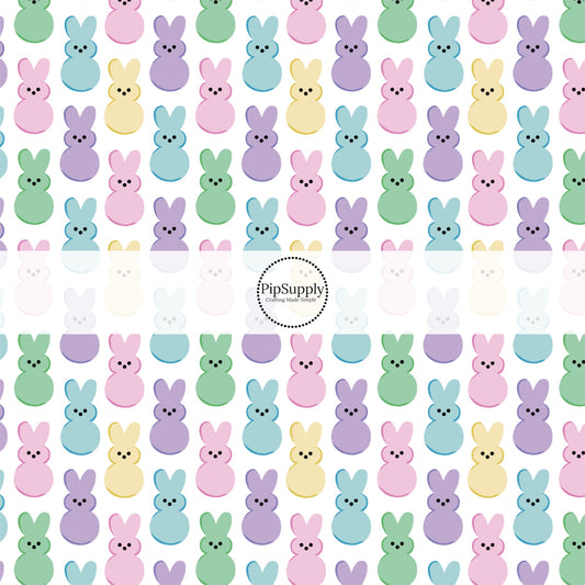 Pastel colored marshmallow bunnies on white fabric by the yard