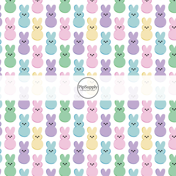 Pastel colored marshmallow bunnies on white fabric by the yard