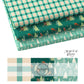 Christmas Fabric layers with blue designssuch as trees, plaid, and deers