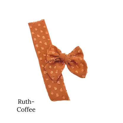 Small sized coffee colored bow with frayed dots on a white background