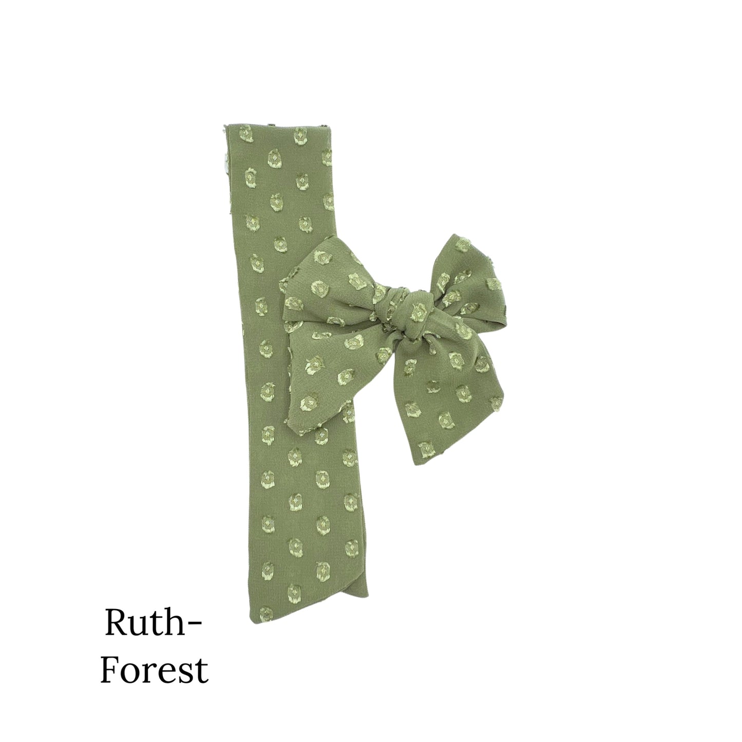 Small green colored bow with frayed dots on a white background